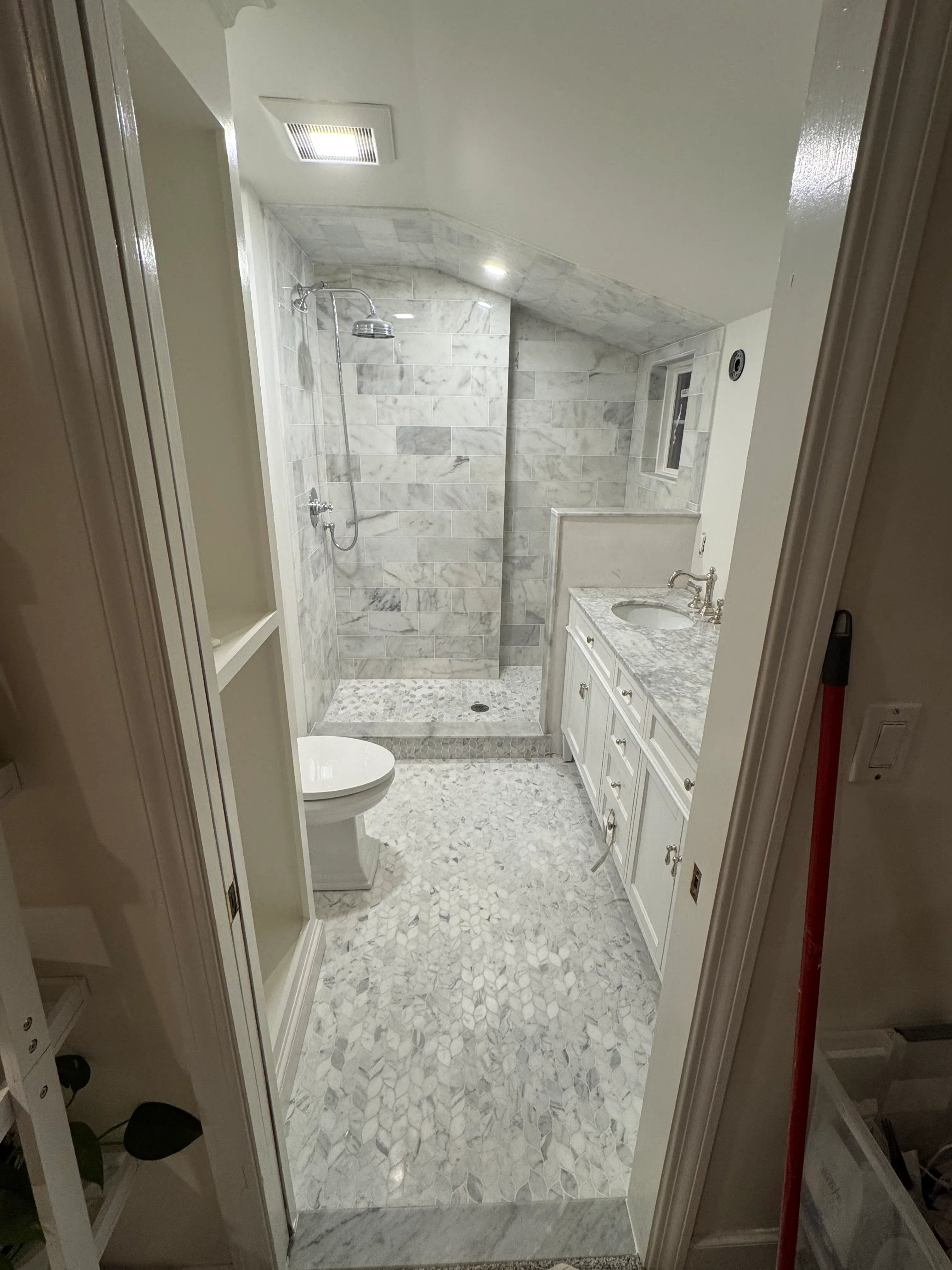 Marble bathroom with hex-mosaic accent wall and tub in progress