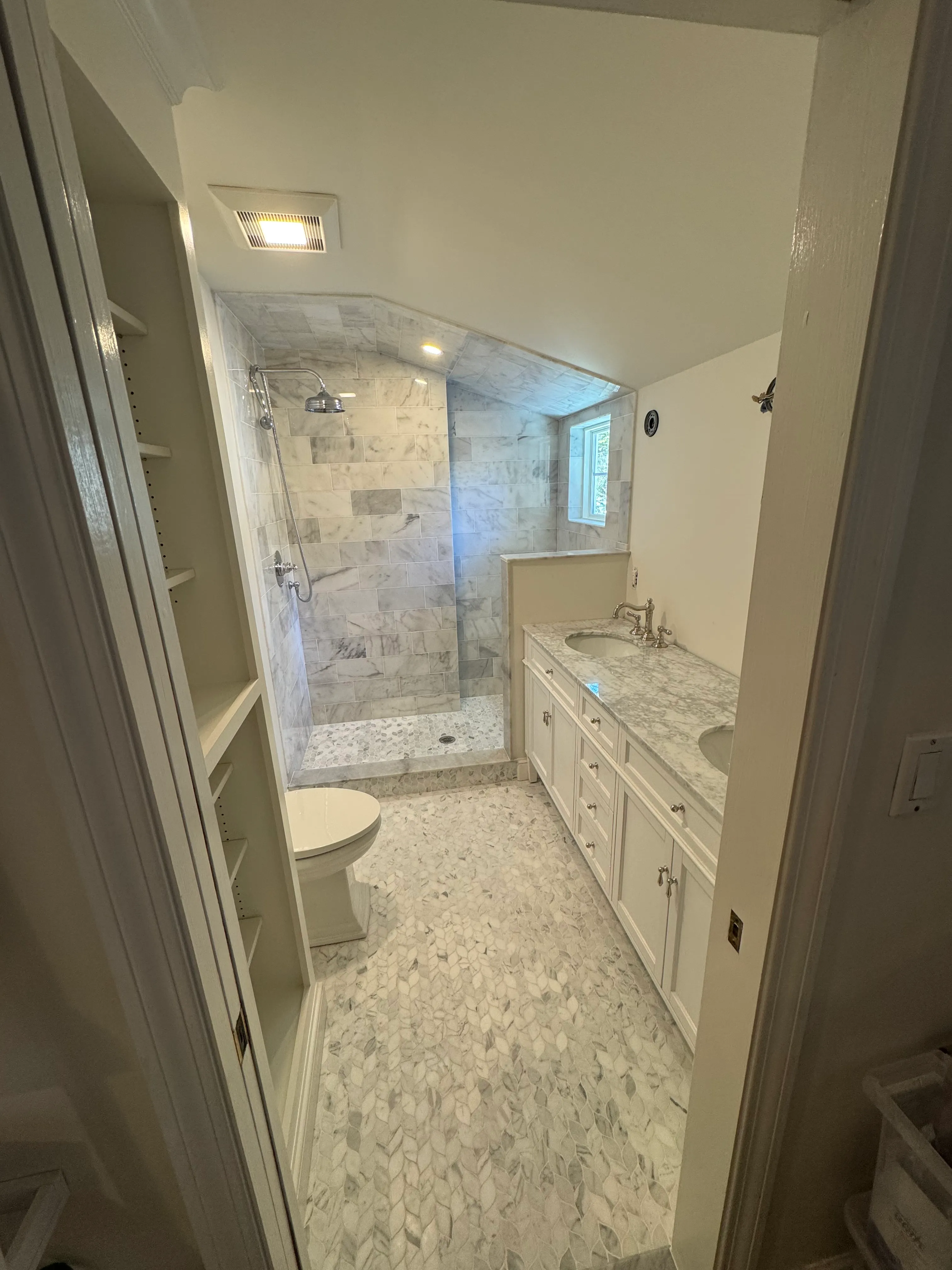 Same marble + hex bathroom — vanity area with skylight, in progress