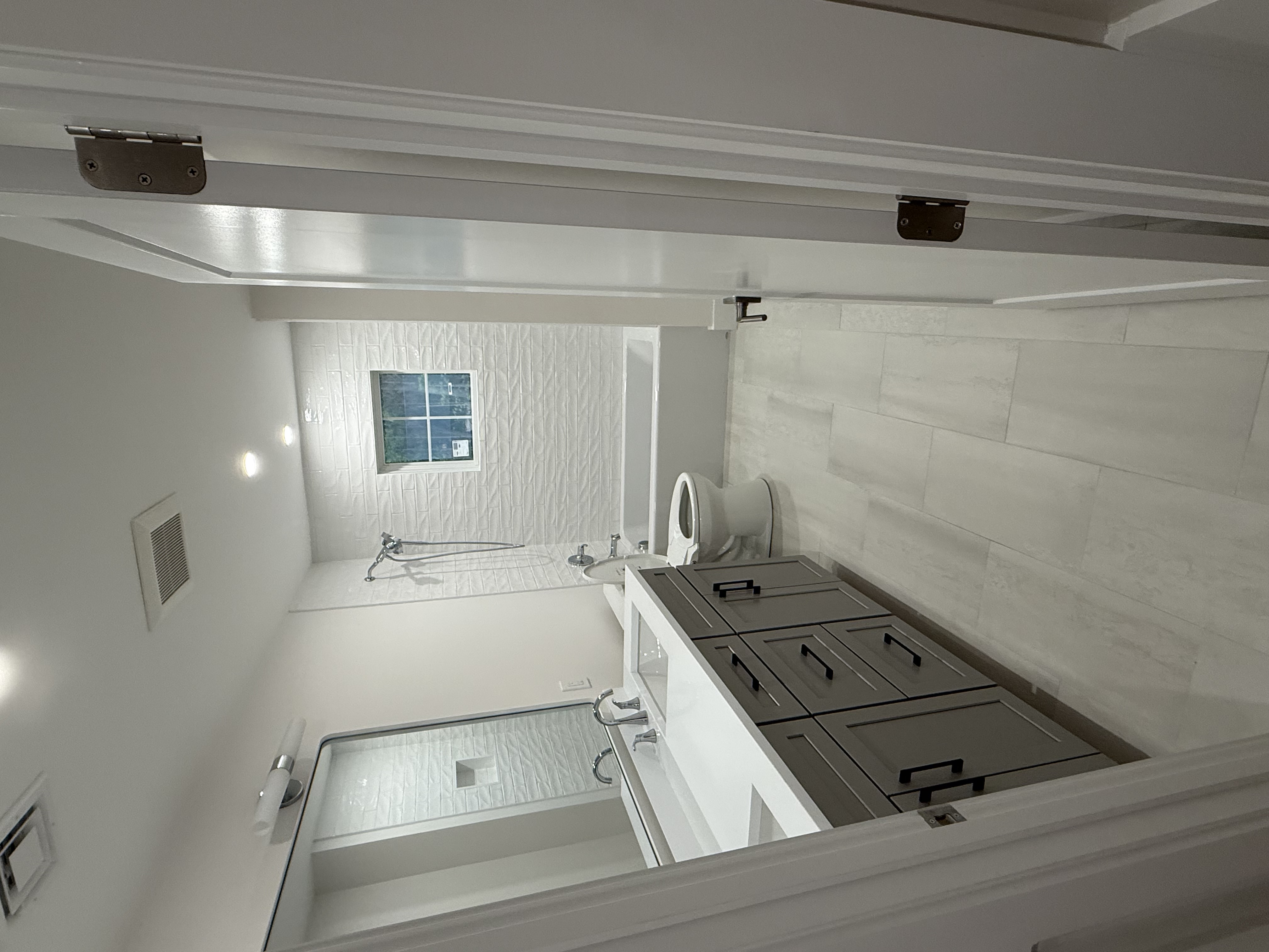 Luxury marble bathroom with dual vanity sinks and glass shower enclosure by Bella and Flora Services